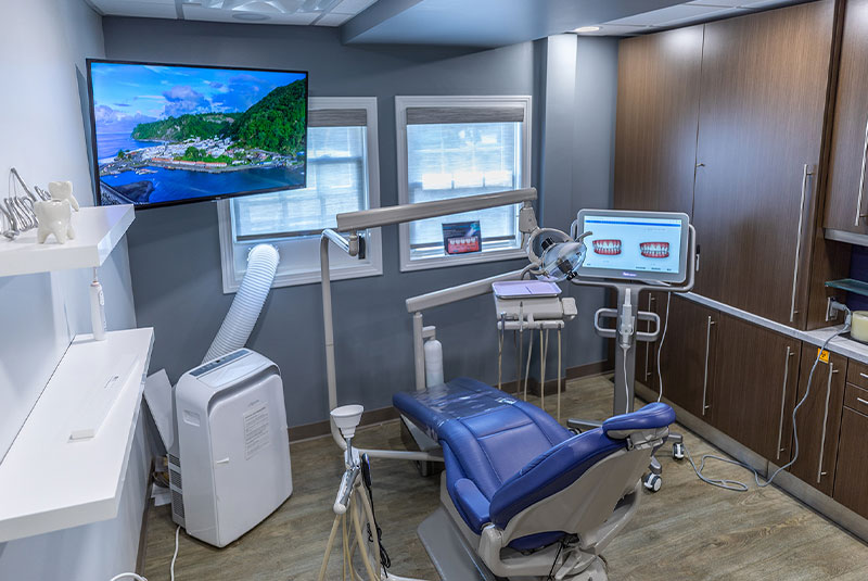 Pearl Dental Associates operatory with large TV screen and CDC approved COVID air filtration system.