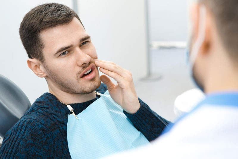 Dental Patient Suffering From Mouth Pain On A Dental Chair, In Scituate, MA