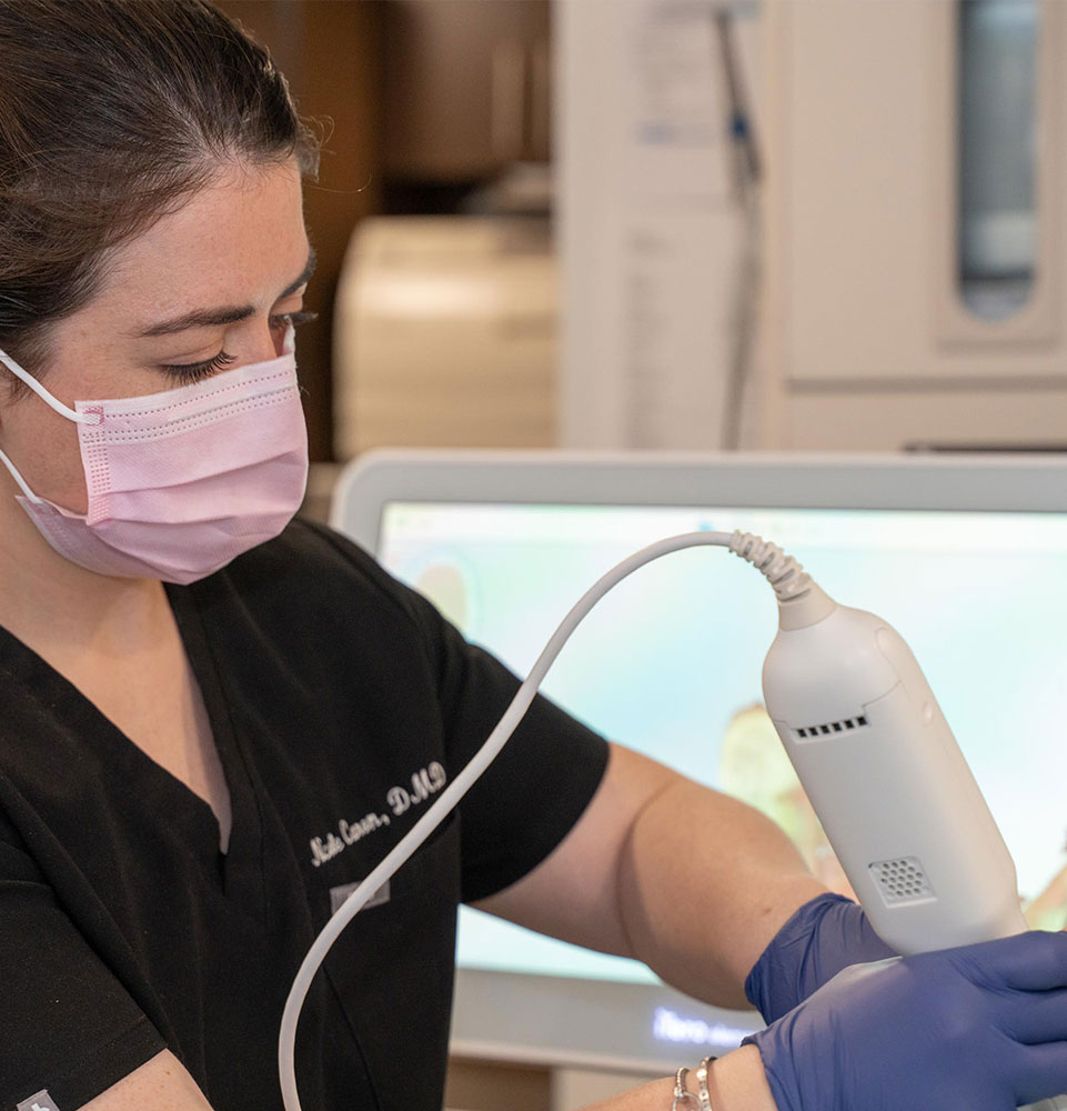 Dr. Caron using dental technology