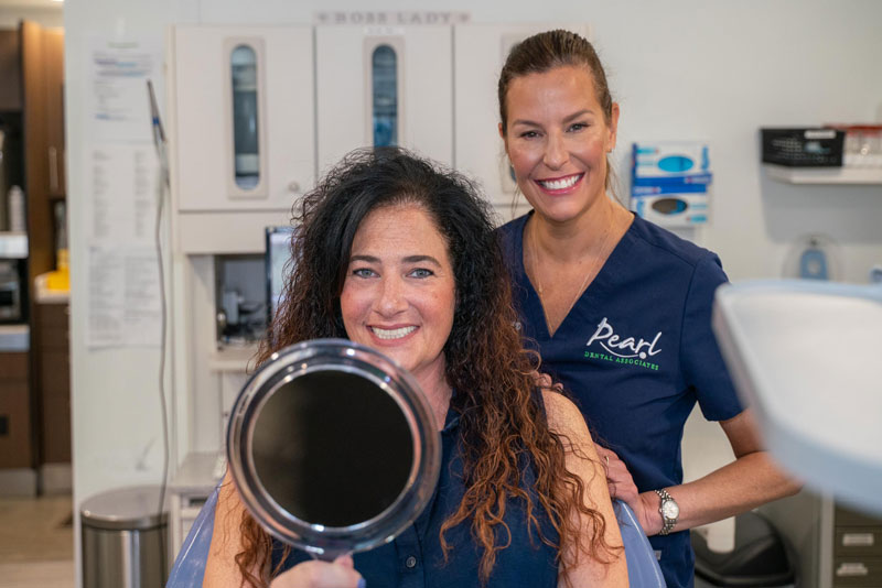 Happy dental implant patient with Dr. Teresa Salem at Pearl Dental Associates near Norwell, MA